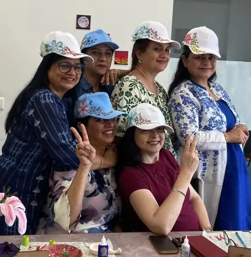Guests wearing the caps they hand-painted, posing together