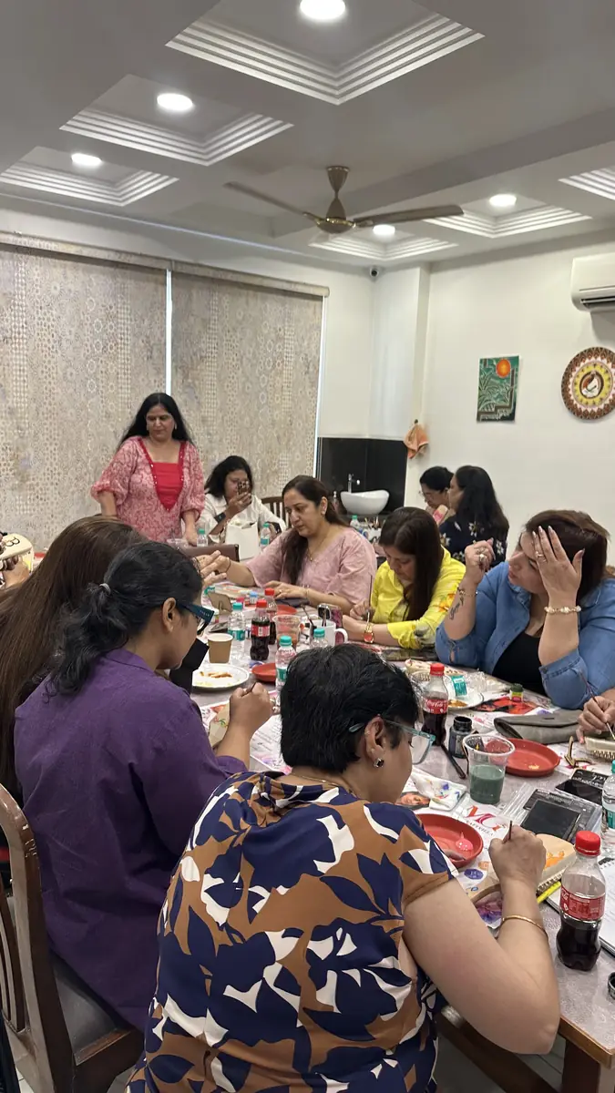 Guests bent over their canvases mid-session, everyone absorbed in their own painting